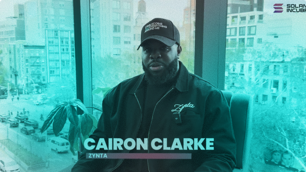 Cairon Clarke, CEO of Zynta, wearing a Zynta jacket and hat during the Solana Incubator program for B2B cross-border stablecoin payment infrastructure