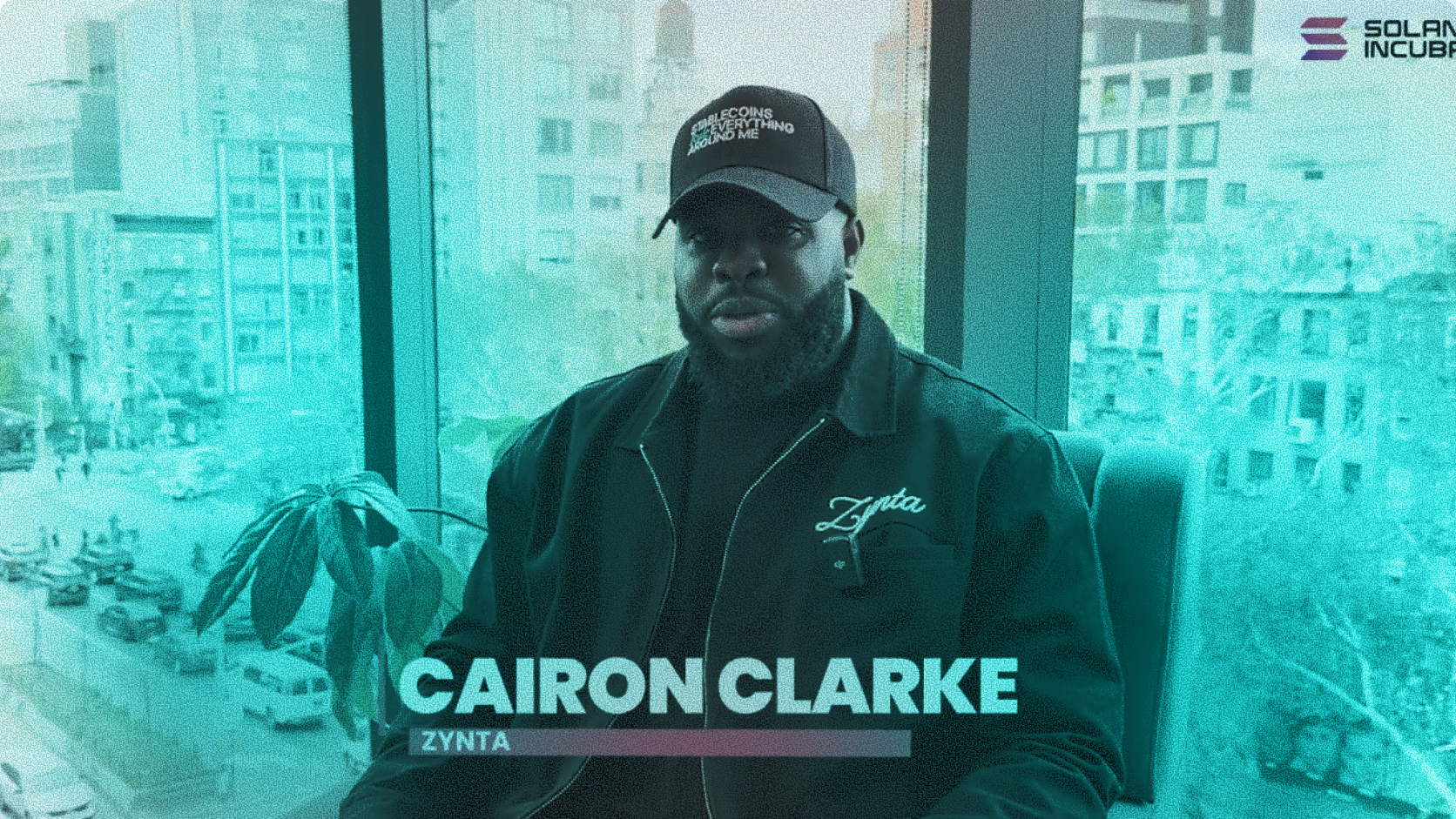Cairon Clarke, CEO of Zynta, wearing a Zynta jacket and hat during the Solana Incubator program for B2B cross-border stablecoin payment infrastructure