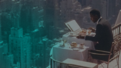 A man in a suit sitting at a table on a high balcony overlooking a vast cityscape with a teal-tinted filter, representing strategic financial perspective and global economic infrastructure