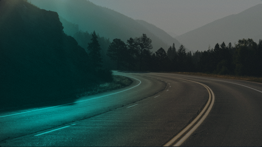 Winding road lit by a cyan neon line at dusk, representing Zynta's direct and frictionless stablecoin-to-fiat conversion pathway for cross-border payments